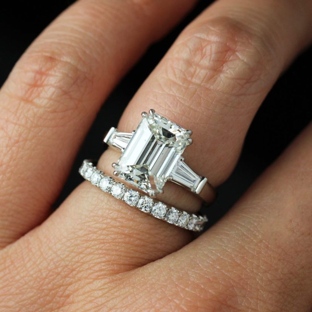 5 carat emerald cut diamong ring on finger