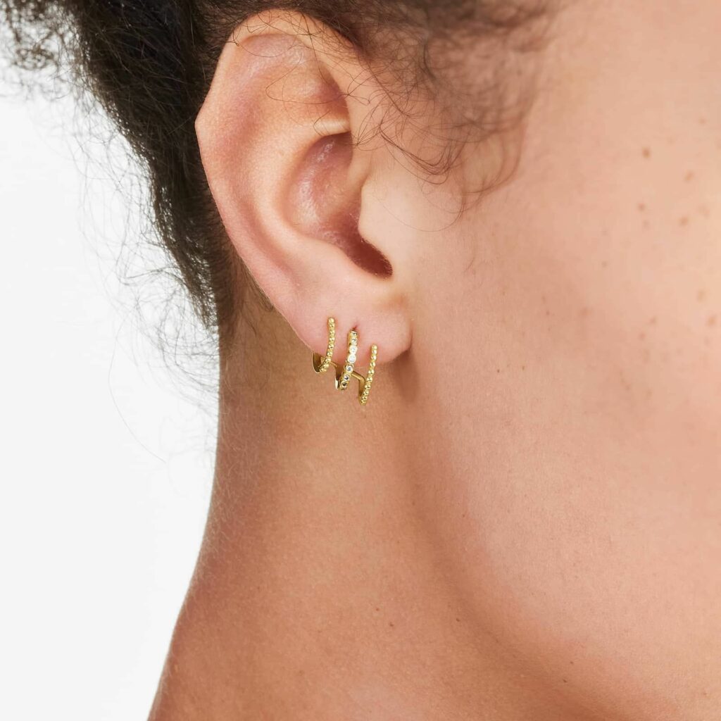 K Yellow Gold Bead And Diamond Three In One Huggie Earring By Brevani on ear