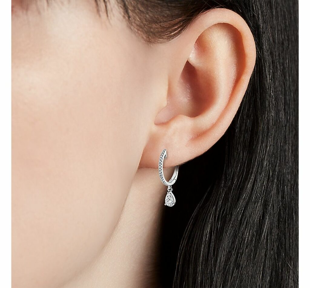 Diamond Huggie Hoop Earrings with Pear Drop in k White Gold on ear