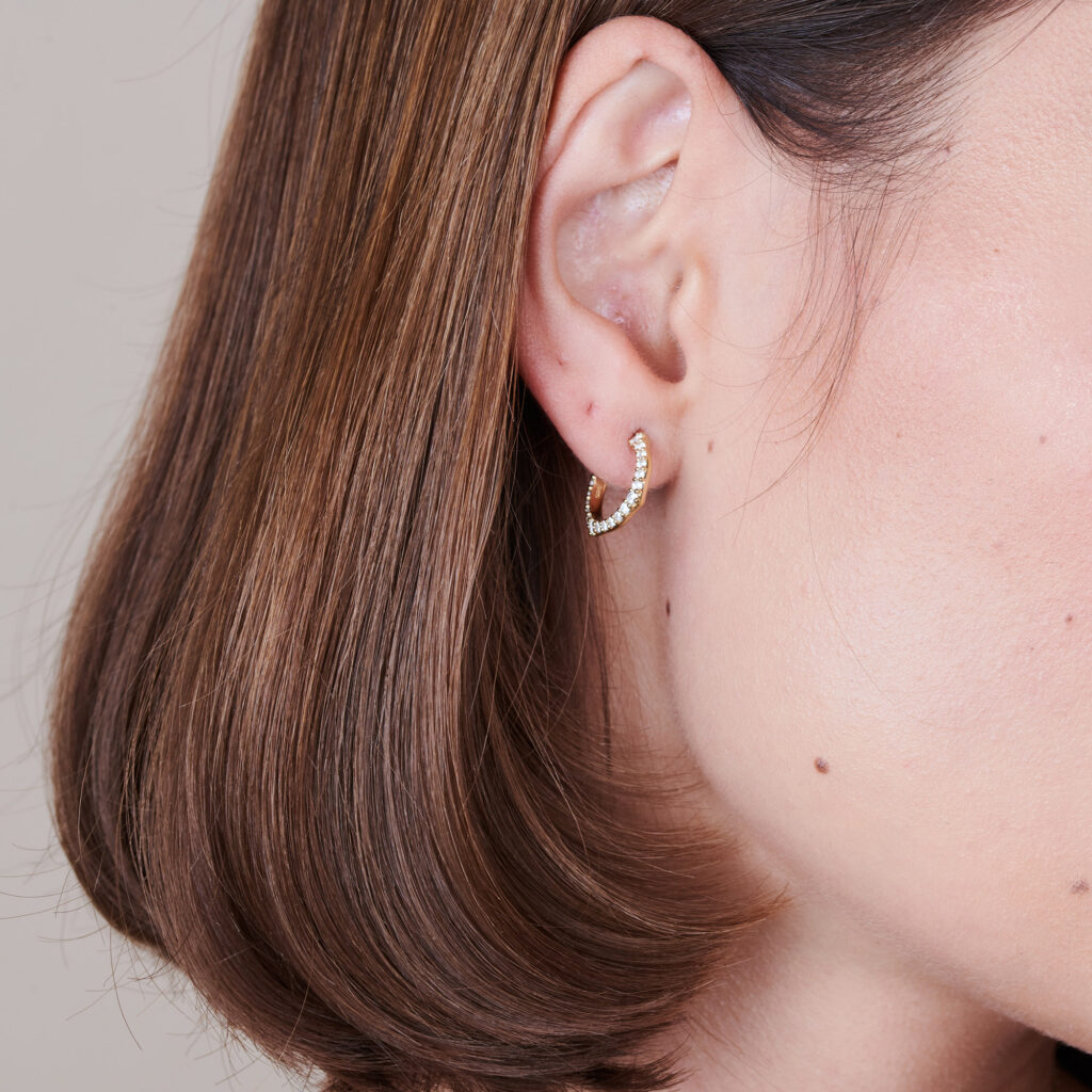 Signature Knife Edge Diamond Huggie Earrings on ear