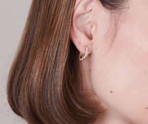 Signature Knife Edge Diamond Huggie Earrings on ear