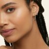 White gold Pave Diamond Huggie Earrings on ear